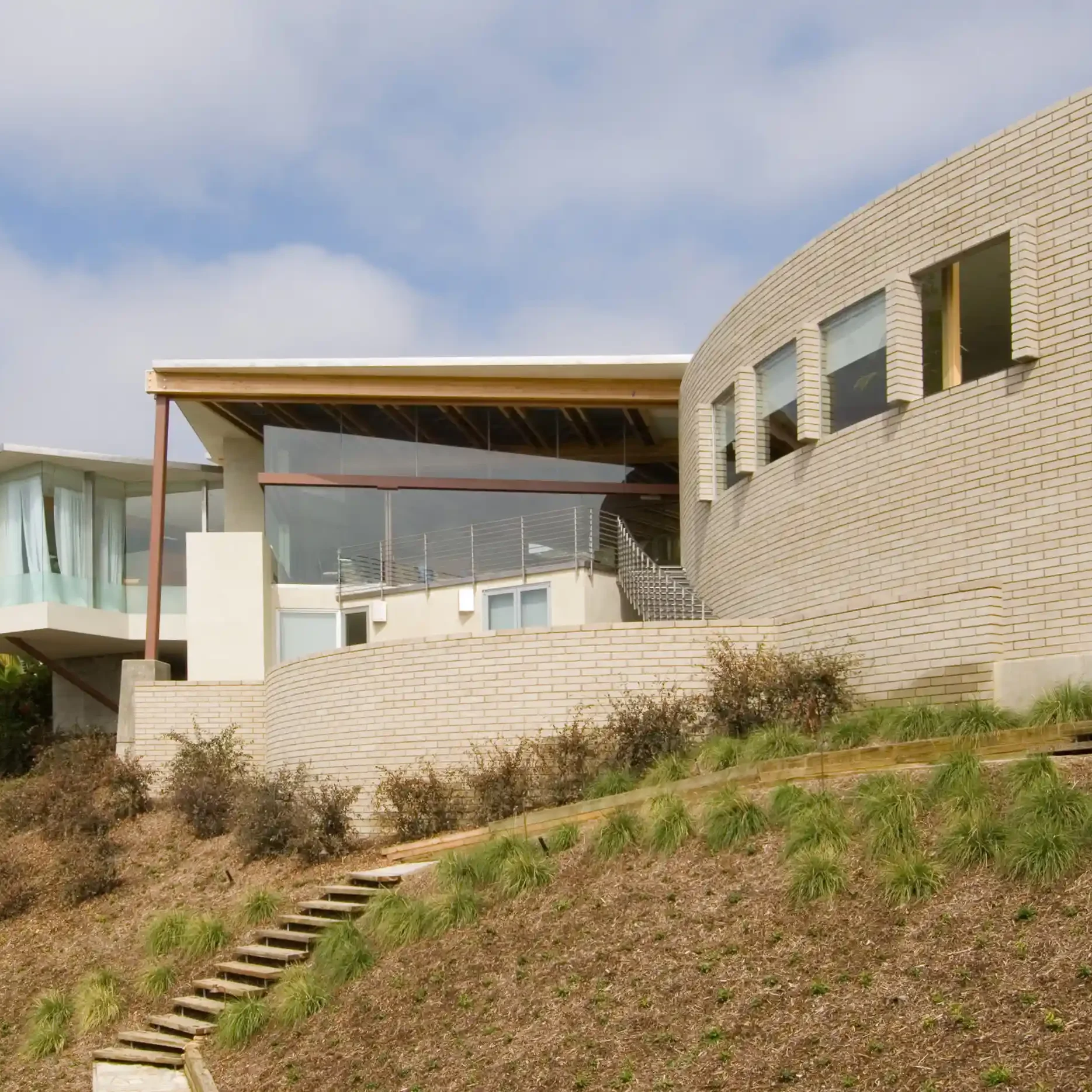 A modern house on the side of a hill.